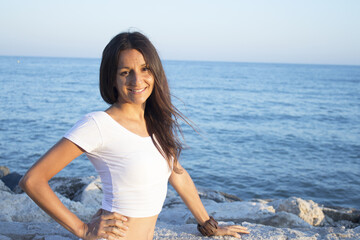 Woman in white dress on the beach