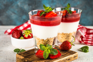 Cheesecake in the glasses with fresh strawberry.