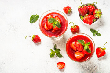 Cheesecake in the glasses with fresh strawberry.