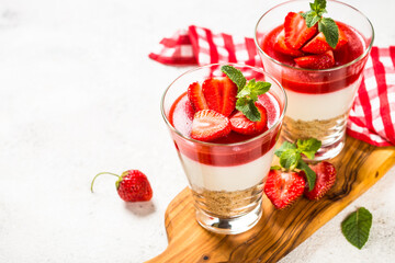 Cheesecake in the glasses with fresh strawberry.
