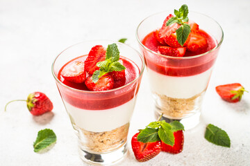 Cheesecake in the glasses with fresh strawberry.