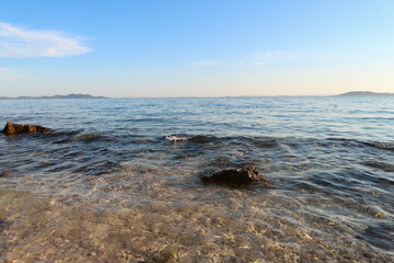 Beautiful rocky beach on the adriatic coast near the town of Pakostane, photographed before sunset