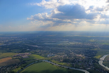 Aerial view of the city with sun rays coming through clouds