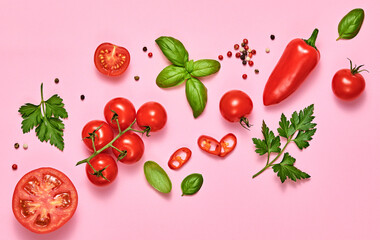 Tomato, basil, spices, bell chili pepper. Vegan diet food, creative composition on pink. Fresh basil, herb, cherry tomatoes layout, cooking sauce colorful concept, top view.