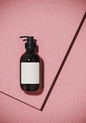 Minimal beauty mockup for product presentation. Cosmetic bottle on pink fabric background. 3d render illustration. 