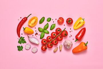 Tomato, basil, spices, bell chili pepper, garlic. Vegan diet food, creative composition on pink. Fresh basil, cherry tomatoes, bell pepper layout, cooking colorful concept, top view.