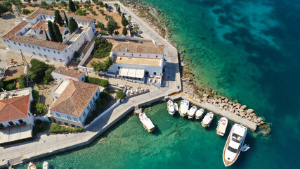 Fototapeta na wymiar Aerial drone bird's eye view photo of picturesque neoclassic houses in historic and traditional island of Spetses with emerald clear waters, Saronic Gulf, Greece