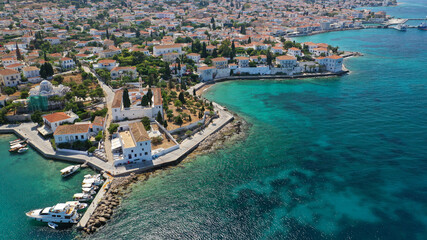 Aerial drone bird's eye view photo of picturesque neoclassic houses in historic and traditional island of Spetses with emerald clear waters, Saronic Gulf, Greece