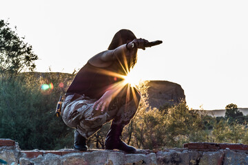 Obraz premium Horizontal shot pointing the gun and the sun peeking through the holes with star tips