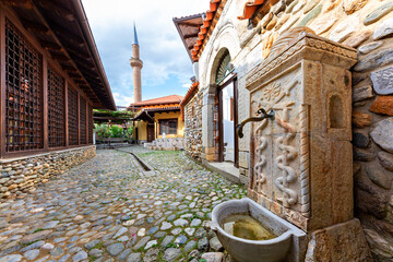 Old fountain with the minaret of Halveti’s Tekke Mosque in the background, Prizren, Kosovo