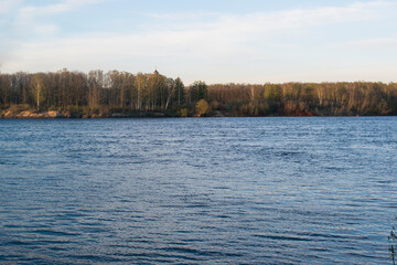 Beautiful landscape with a river flowing slowly in small waves during sunset.