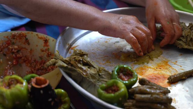 A woman is preparing stuffed grape leaves, leaf wrap, Turkish food culture and stuffed leaves