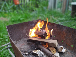 Fire, barbecue on the background of green grass