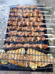Grill. Top view of pork kebab and baked fish prepared in the smoke on the grill