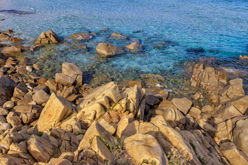 Textured rocks formations on the beach in Villasimius, Sardinia, Italy. Holidays, the best beaches in Sardinia.