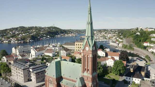 Trinity Church And The Seaside Town Of Arendal In Agder County, Norway.  - aerial drone - orbit shot