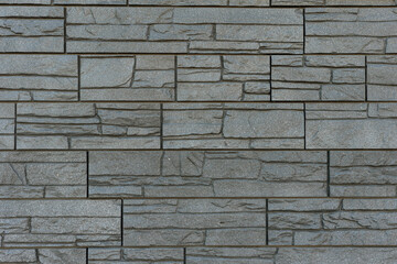 Wall with a texture of gray stone.