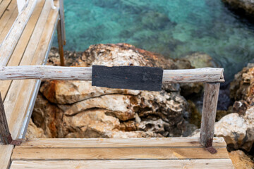 Fototapeta na wymiar Wooden copy space on wooden fence by the sea