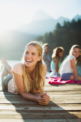 Woman laying on dock and laughing