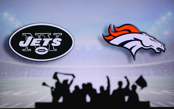 New York Jets vs. Denver Broncos. Fans support on NFL Game. Silhouette of supporters, big screen with two rivals in background.