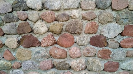 Stones fixed with cement mortar. A wall of boulders. 