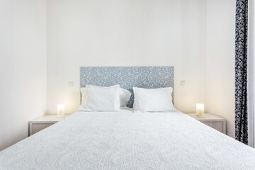 Minimalistic bedroom in bright colors and white walls. European style.