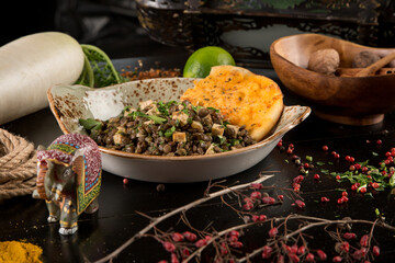 black bean salad in a plate decorated with colorful spices and vegetables