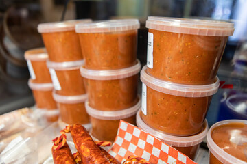 Variety of healthy and delicious fresh tomato spaghetti sauces ready for customers on the display refrigerator of a bistro buffet restaurant.