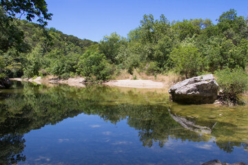 Fototapeta na wymiar a blue sky reflected in a quite creek