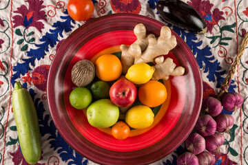 Fruits and vegetables lie in a plate top view