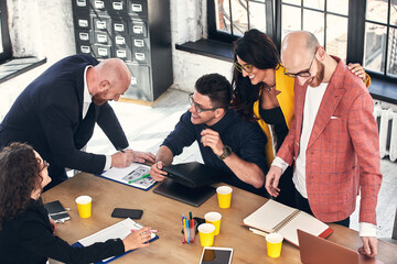 Business meeting in an office, the businesspeople are discussing a document