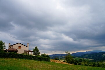 Fototapeta na wymiar rural landscape with a house and clouds