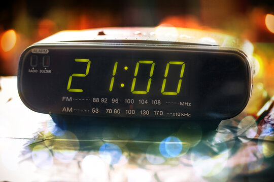 Black digital alarm radio clock.Alarm radio clock indicating time to wake  up.Digital clock closeup displaying 21:00 o'clock. Digital radio clock  displaying 21:00 on bokeh background Stock Photo | Adobe Stock