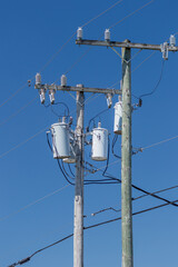 Powerline transformers against blue sky