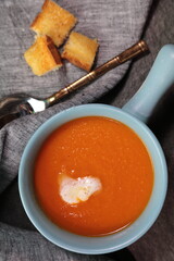 Homemade Tomato carrot soup in a bow made with frsh Tomatoes.