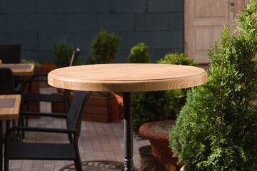wooden round table in open air cafe