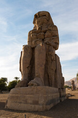 Fototapeta na wymiar Colossi of Memnon Luxor Thebes against the background of dawn in the Egypt