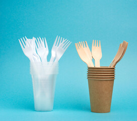 non-degradable plastic cups and fork from disposable tableware and a set of dishes from environmental recycled materials
