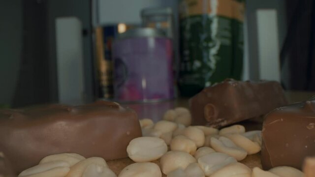Macro close up view of the broken chocolate bar of chocolate with cashew nuts and coconut.