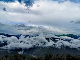 Naklejka na ściany i meble clouds over the mountains