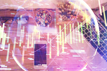 Double exposure of business theme hologram over desktop with phone. Top view. Mobile international trade connection concept.
