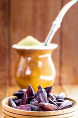 Pinion bowl with chimarrão in the background, spot focus. Typical drink and food from Rio Grande do Sul, Brazil.