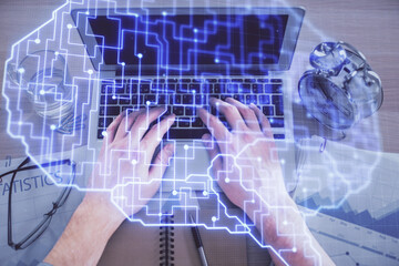 Double exposure of man's hands typing over computer keyboard and brain hologram drawing. Top view. Ai and data technology concept.