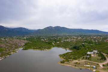 Fototapeta na wymiar Aerial view of the lake and mountains with village below