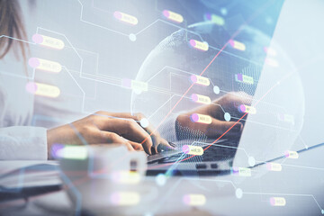 Double exposure of woman hands working on computer and world map hologram drawing. International technology business concept. © peshkova