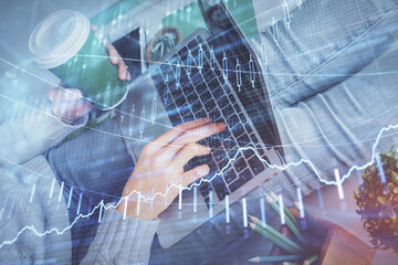 Double exposure of woman hands typing on computer and forex chart hologram drawing. Stock market invest concept.