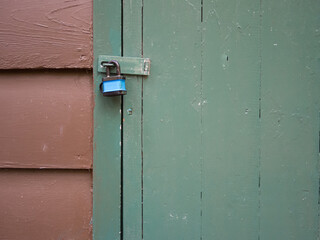 Door latch locked with a flimsy padlock