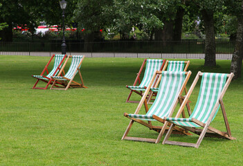 Public park in London United Kingdom near Buckingham palace showing flower beds, trees and relaxing...