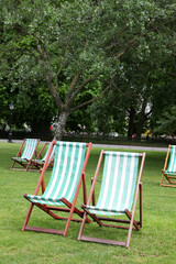 Public park in London United Kingdom near Buckingham palace showing flower beds, trees and relaxing...