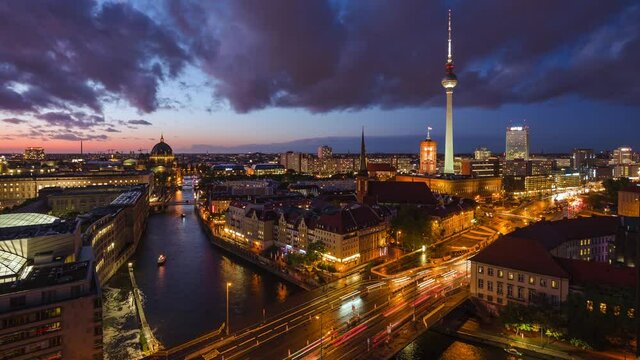Berlin, Germany, day to night timelapse view of Berlin skyline including iconic TV Tower and tour boats on the Spree river.